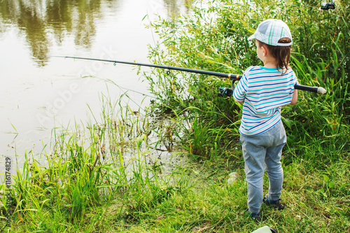 child fishing on the lake