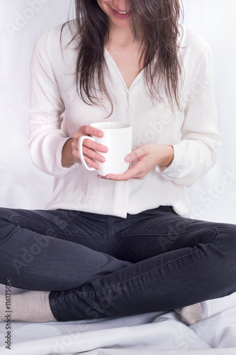 Hipster girl drinking coffee on a ground 