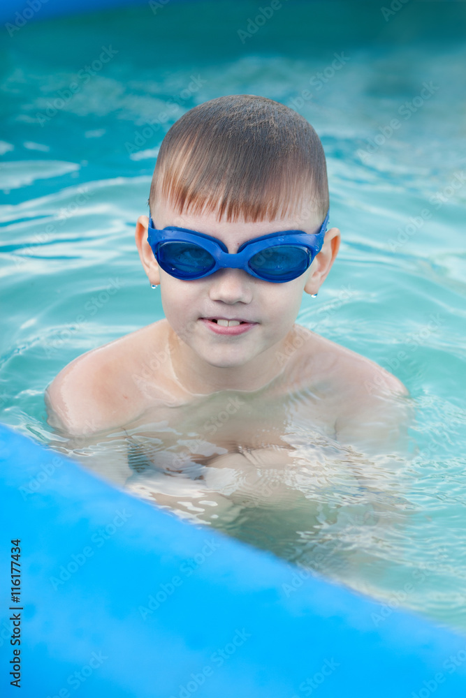 Little boy having fun in the water pool
