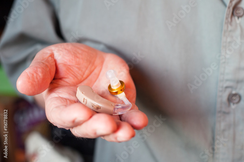 man holding hearing aid 
