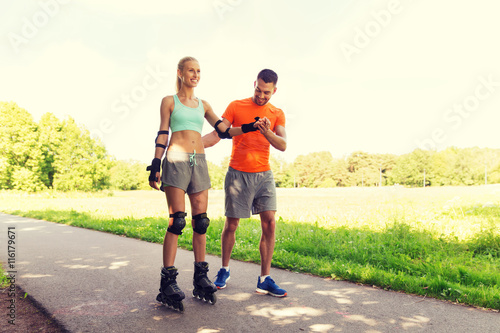happy couple with roller skates riding outdoors
