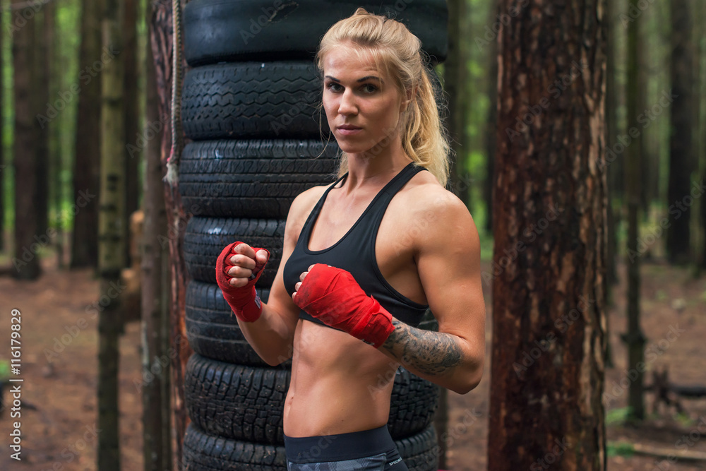 Woman boxer professional fighter posing in boxing stance, working out  outdoors Stock Photo | Adobe Stock