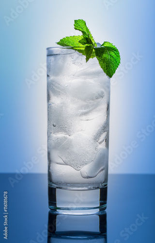 Cool glass of pure water on a blue background
