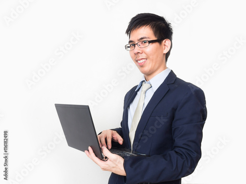 Asian business man wear glasses on professional suit with a lapt