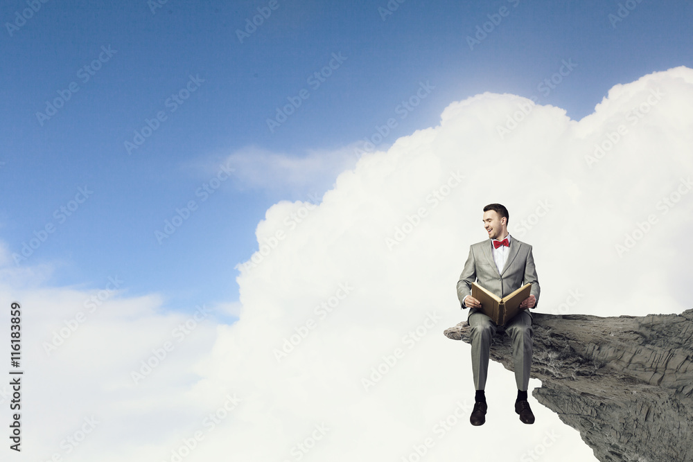 Businessman reading old book . Mixed media Businessman reading old book . Mixed media