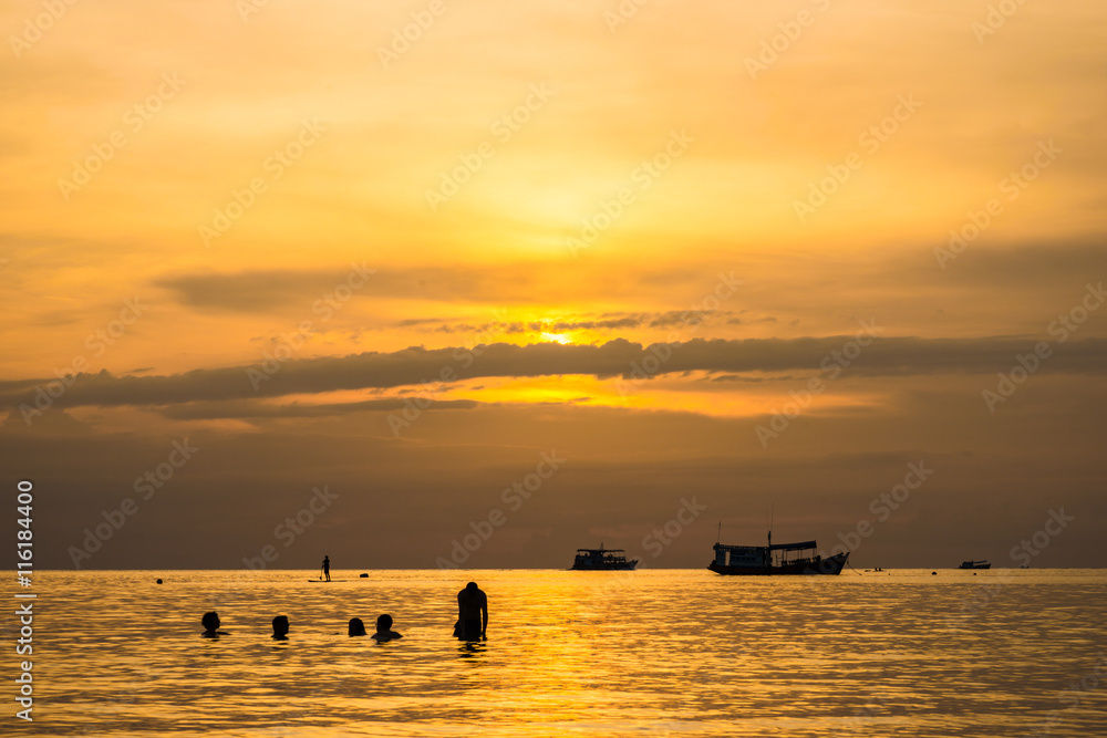The beautiful silhouette evening sunset with people on beach at