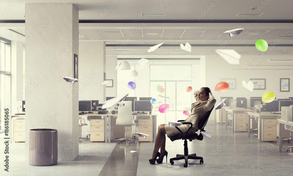 Businesswoman having rest in office . Mixed media Businesswoman having rest in office . Mixed media