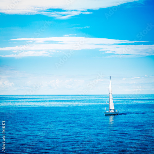 White Yacht Sailing in Calm Blue Sea