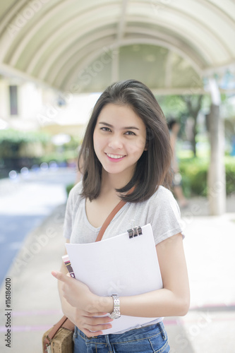 A portrait of an Asian university student on campus