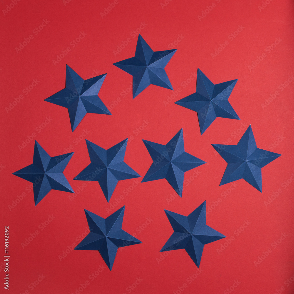 set of blue paper stars on red background set of blue paper stars on red background