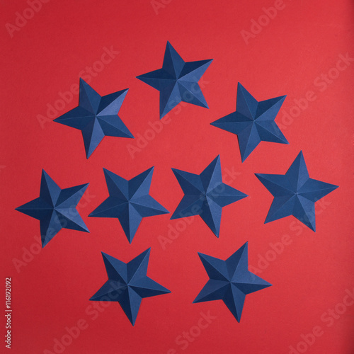 set of blue paper stars on red background