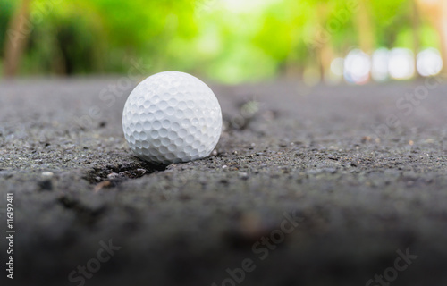Golf ball on Lane Blacktop rough roads