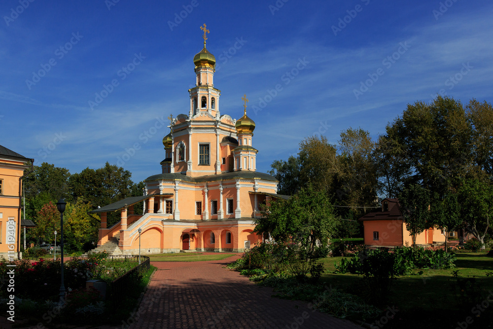 Traditional orthodox temple with gold domes against the blue sky.