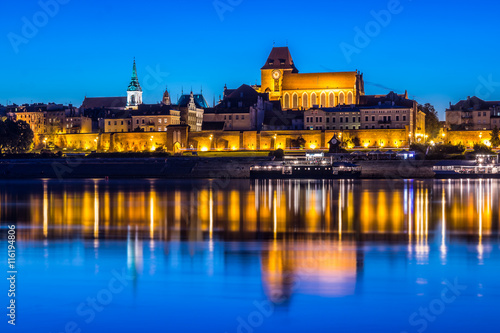 Torun Old Town at night reflected in Vistula river, Poland © kasaks