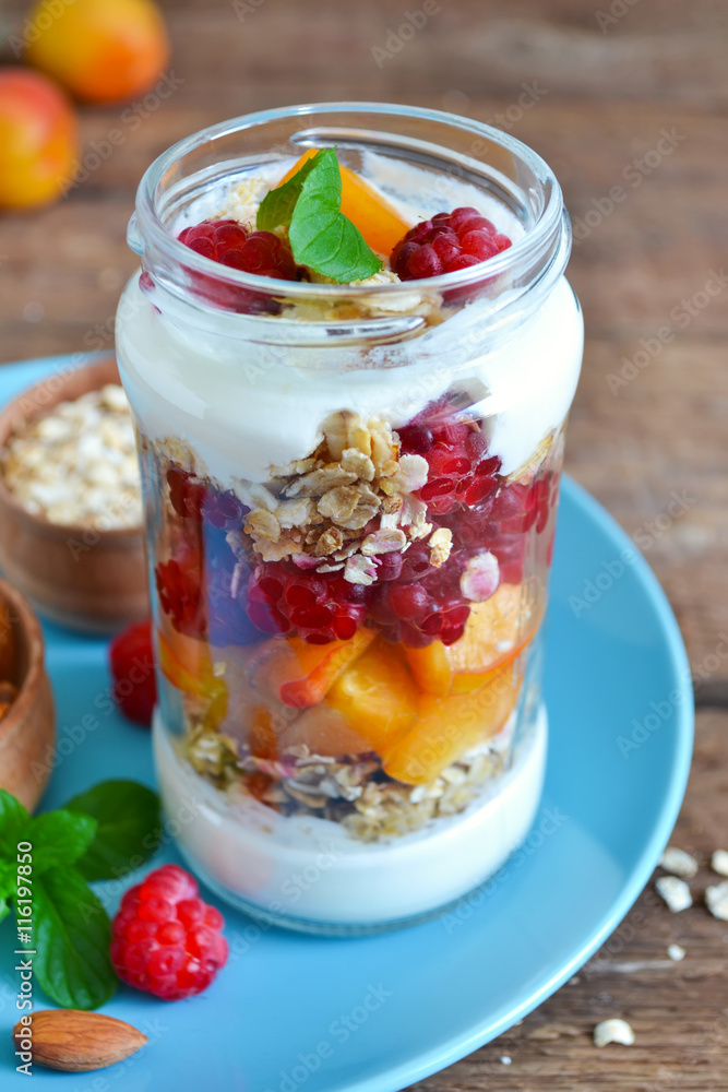 Homemade yogurt with granola, almonds, peaches and raspberries o Homemade yogurt with granola, almonds, peaches and raspberries o