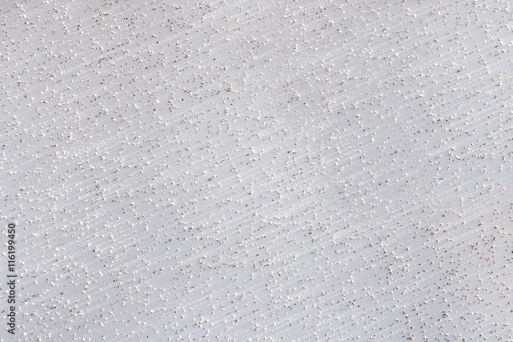 Abstraktes Muster einer weißen Wand mit kleinen herausstehenden Steinen