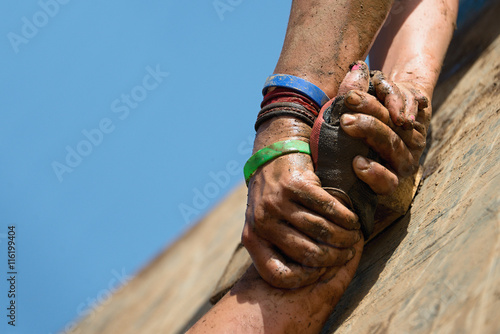 Couple hold hands,help when overcoming hindrances mud photo