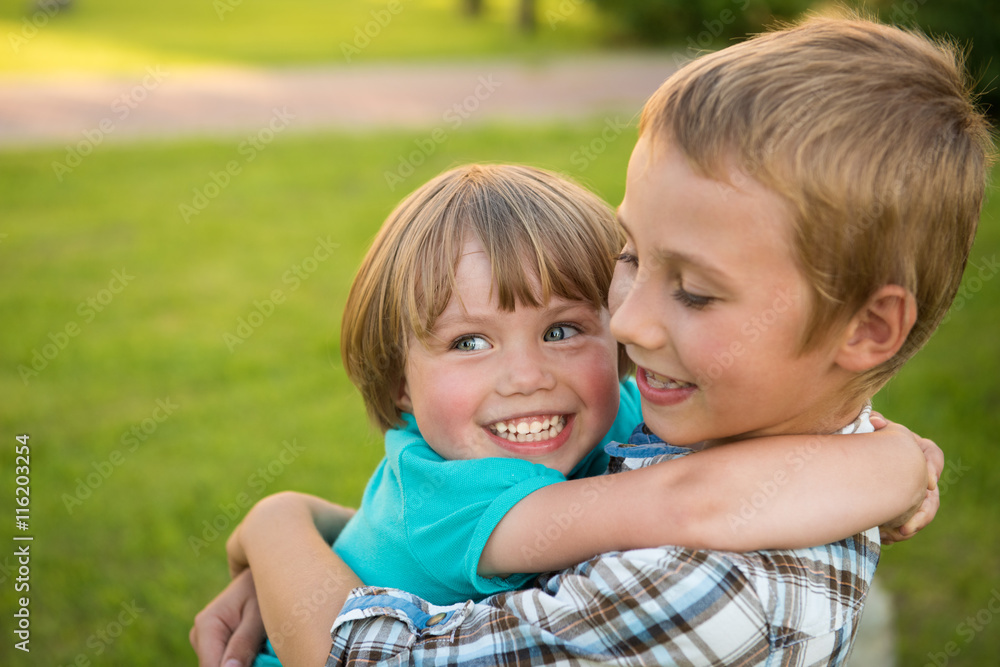 Boy and girl hugging. Green meadow. Funny kids. Boy and girl hugging. Green meadow. Funny kids.