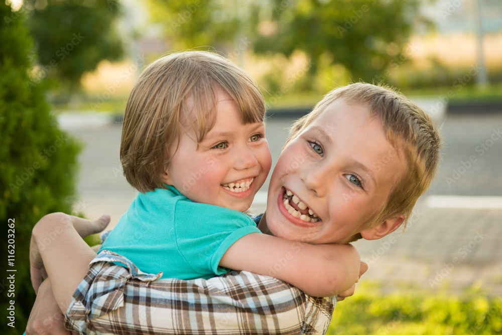 Boy and girl hugging. Green meadow. Funny kids. Boy and girl hugging. Green meadow. Funny kids.