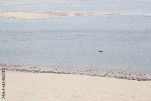 boat in the sea near the coast and an island