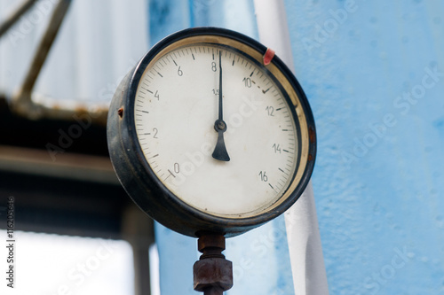 Pressure meter in natural gas processing plant in bright sunny summer day photo