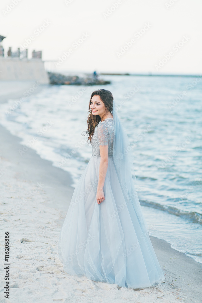 Cheerful bride at the seashore