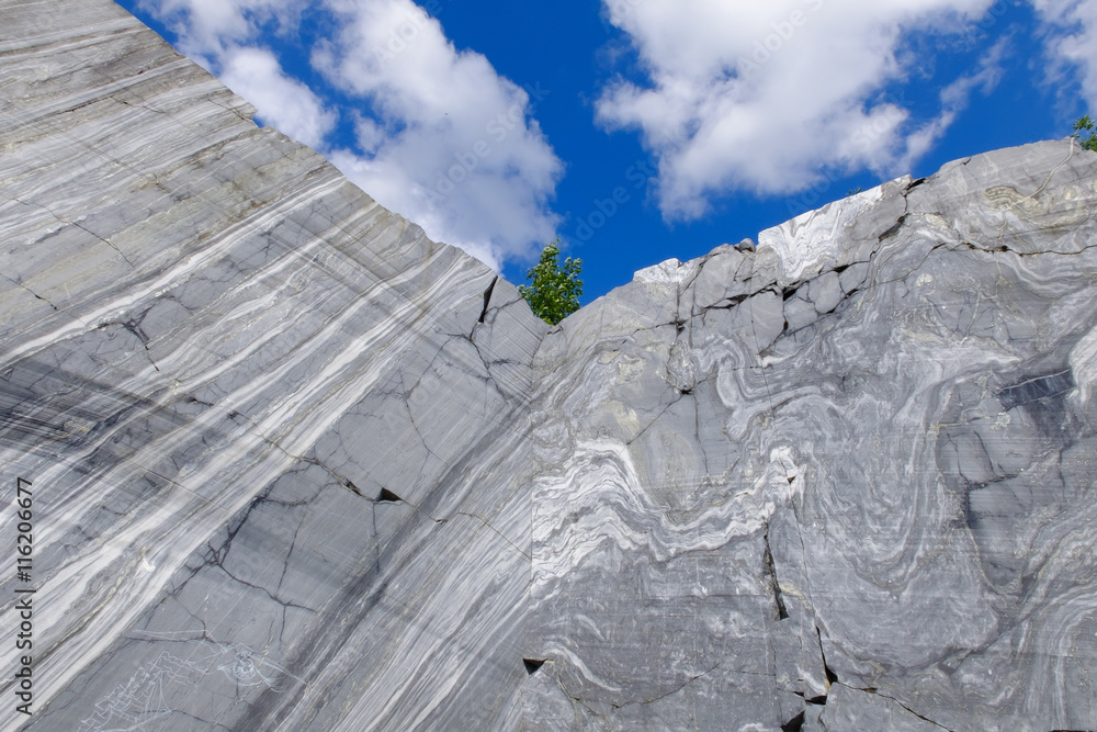 Rock cut white and grey marble in natural environment. Marble career