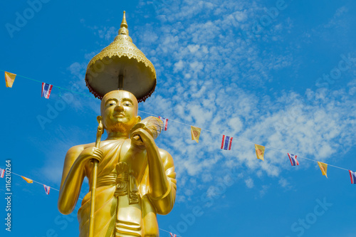 Samutprakarn, Thailand - July 19; Thai Buddhist decorate temple and Statue with Thailand flag and yellow Buddhism symbol flag to celebrating on Asalha Puja day before Khao Phansa day. photo