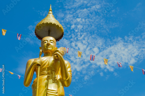 Photography Samutprakarn, Thailand - July 19; Thai Buddhist decorate temple and Statue with Thailand flag and yellow Buddhism symbol flag to celebrating on Asalha Puja day before Khao Phansa day