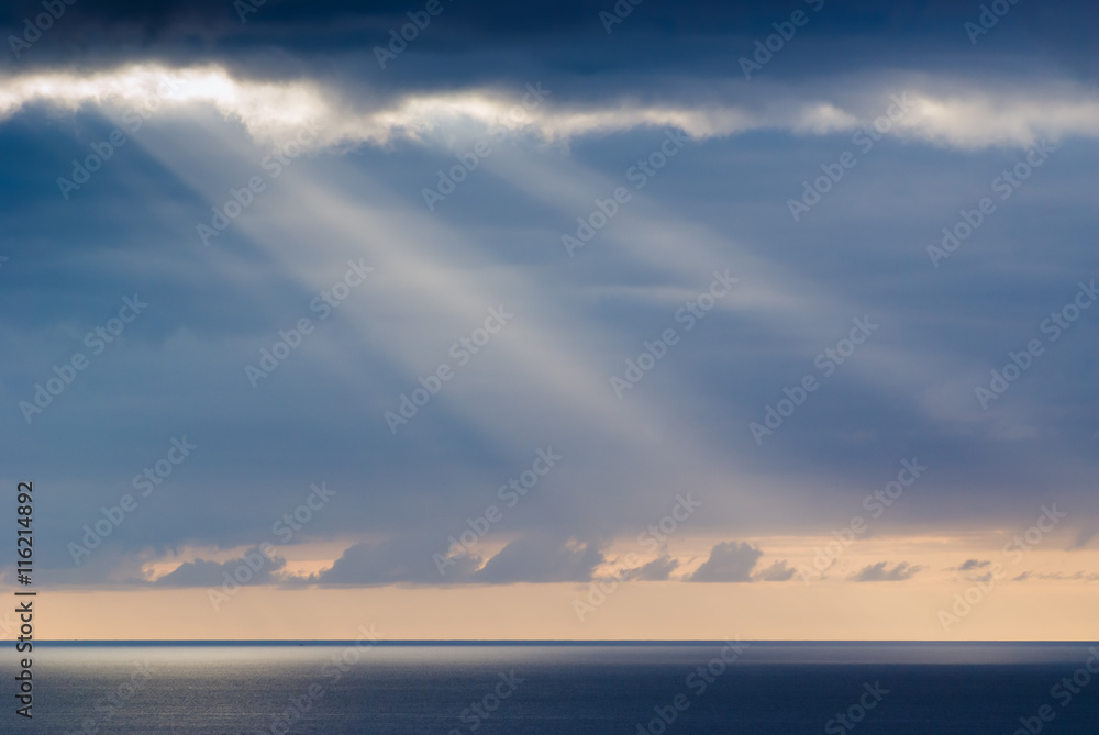 The sun's rays through the clouds in the sky on the peninsula Jandia. Fuerteventura. Canary Islands. Spain