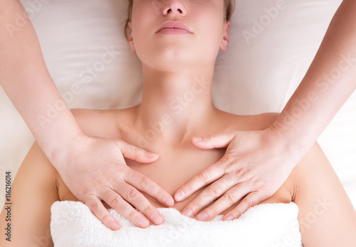 Therapist doing massage releasing tension by pressing chest on pectoralis major muscle