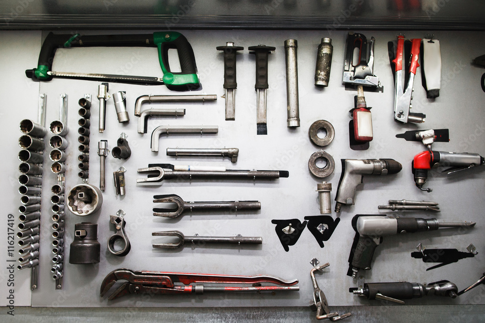 Professional mechanical tools in modern auto service. Set of different instruments in big workshop Professional mechanical tools in modern auto service. Set of different instruments in big workshop
