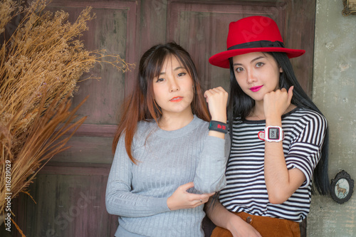 Two youth and technology. Amazed young woman with smartwatch using mobile phone. photo