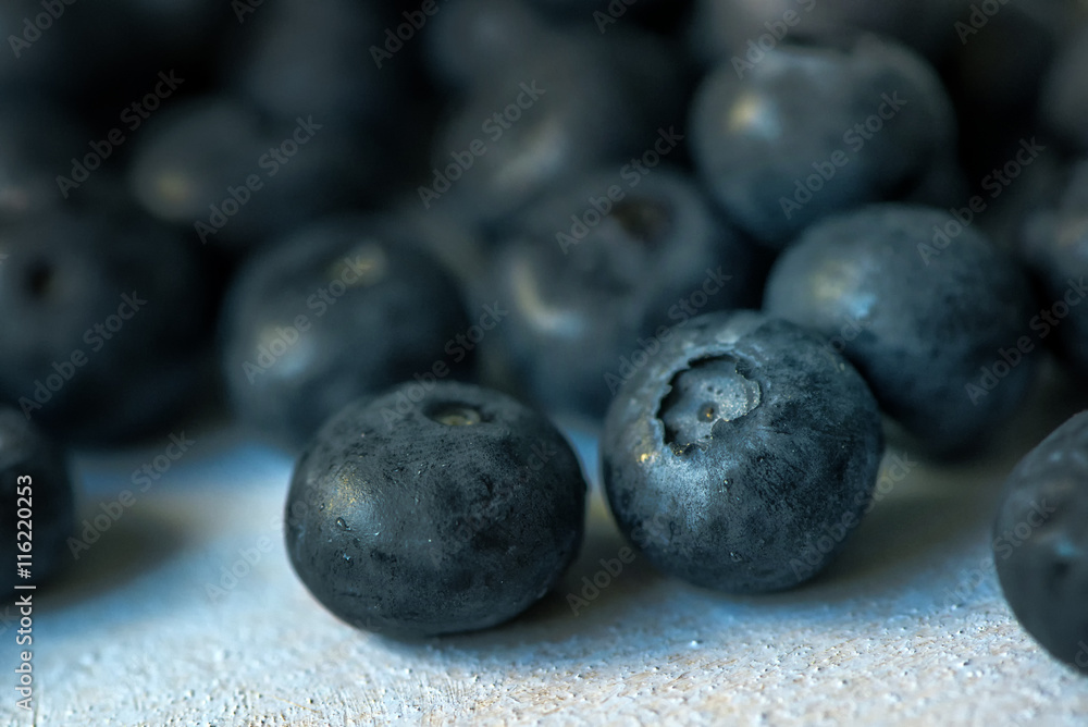 Macro image of blueberry pile on wooden table Macro image of blueberry pile on wooden table