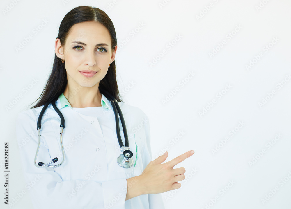 Young female doctor with stethoscope pointing to the copy space for product or text. Advertisement concept. Young female doctor with stethoscope pointing to the copy space for product or text. Advertisement concept.