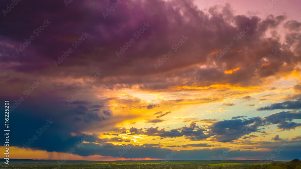 The beautiful sunset on the background of cloud stream. Wide angle