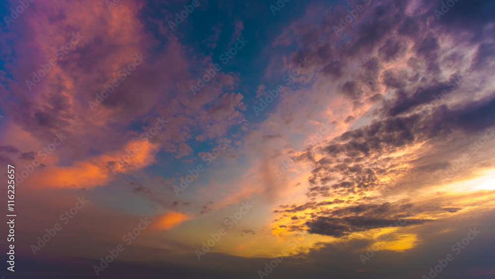The beautiful sunset on the background of cloud stream. Wide angle
