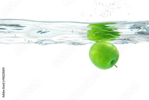 Water splash. Green apple under water. Air bubble and transparen