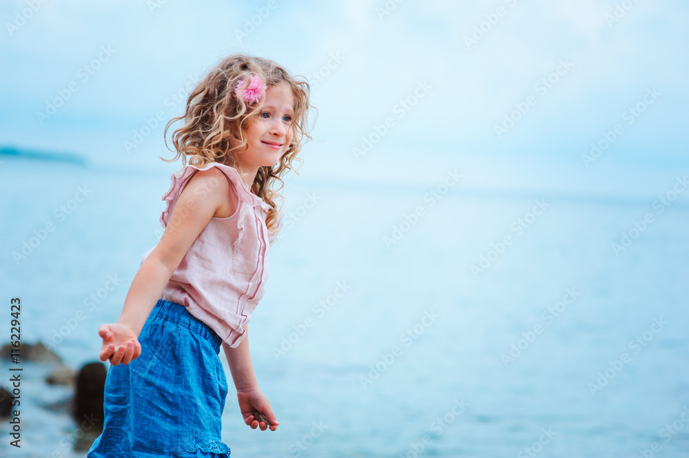 adorable dreamy child girl relaxing on the beach in Piran, Slovenia adorable dreamy child girl relaxing on the beach in Piran, Slovenia