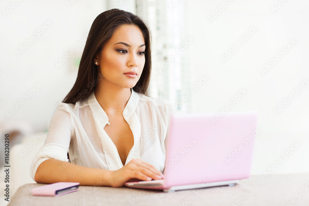 Beautiful asian woman working on laptop Beautiful asian woman working on laptop