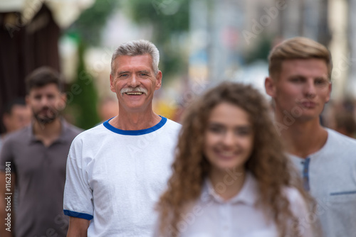 The group of people stand behind each other