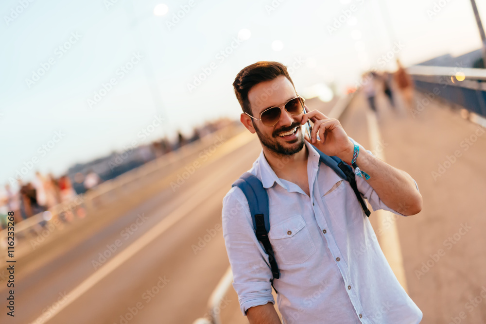 Happy handsome man talkin on phone