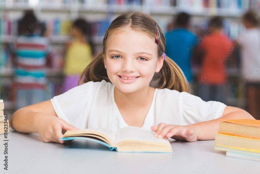 Schoolgirl reading book in library Schoolgirl reading book in library