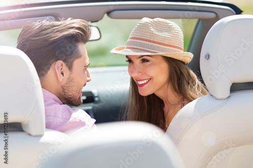 Couple enjoying a drive in a convertible   © pikselstock