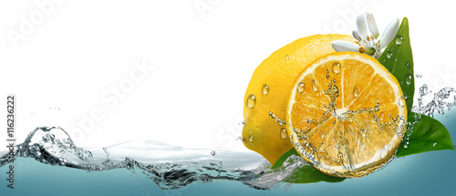 Juicy, ripe citrus lemon on a background of splashing water. 