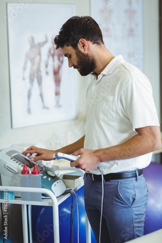 фотографія Physiotherapist using therapeutic ultrasound
