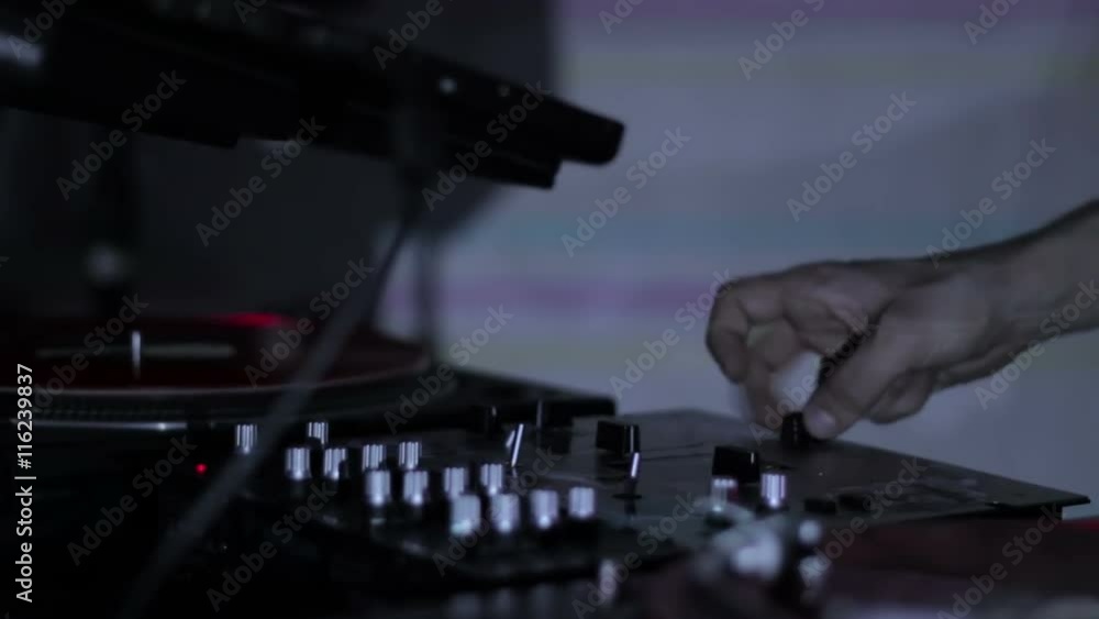 DJ scratching vinyl records and mixing on the Decks at a disco in Nightclub loop video DJ scratching vinyl records and mixing on the Decks at a disco in Nightclub loop video