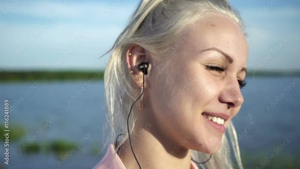 Beautiful girl with headphones posing in front of camera Beautiful girl with headphones posing in front of camera