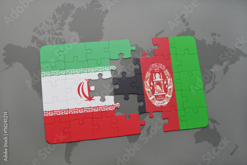 puzzle with the national flag of iran and afghanistan on a world map background.