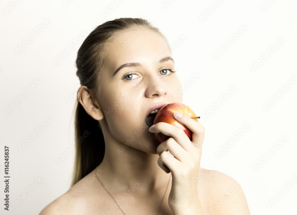 beautiful naked young woman eating an apple. healthy food - strong teeth concept beautiful naked young woman eating an apple. healthy food - strong teeth concept